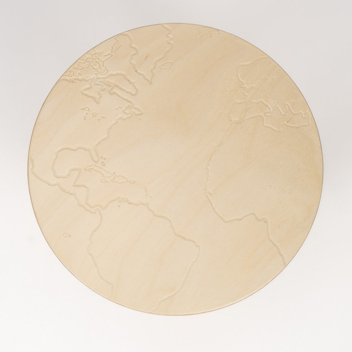 Round wooden stool with embossed world map design on a white background