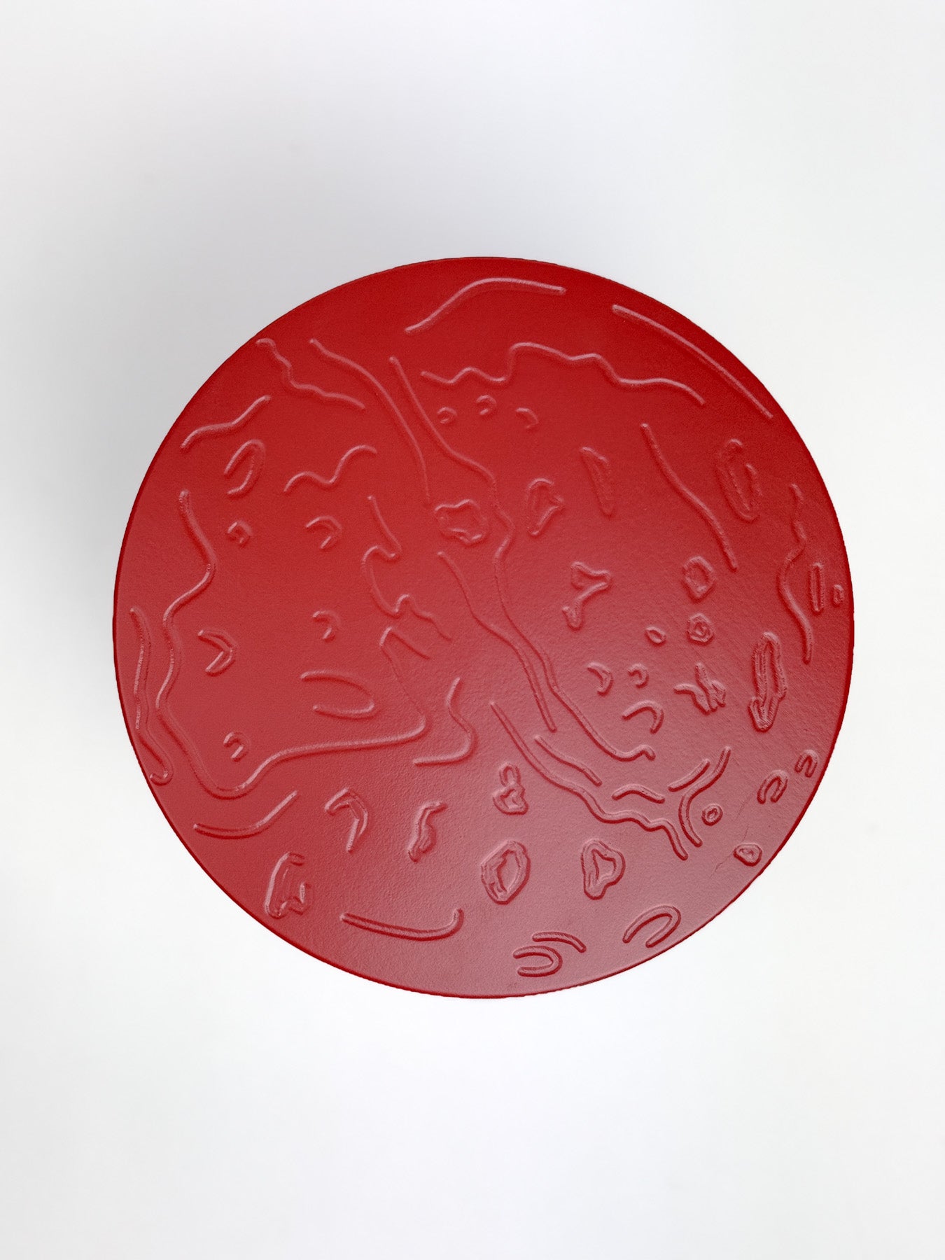 Red rocket stool with embossed design of Mars on the top on a white background