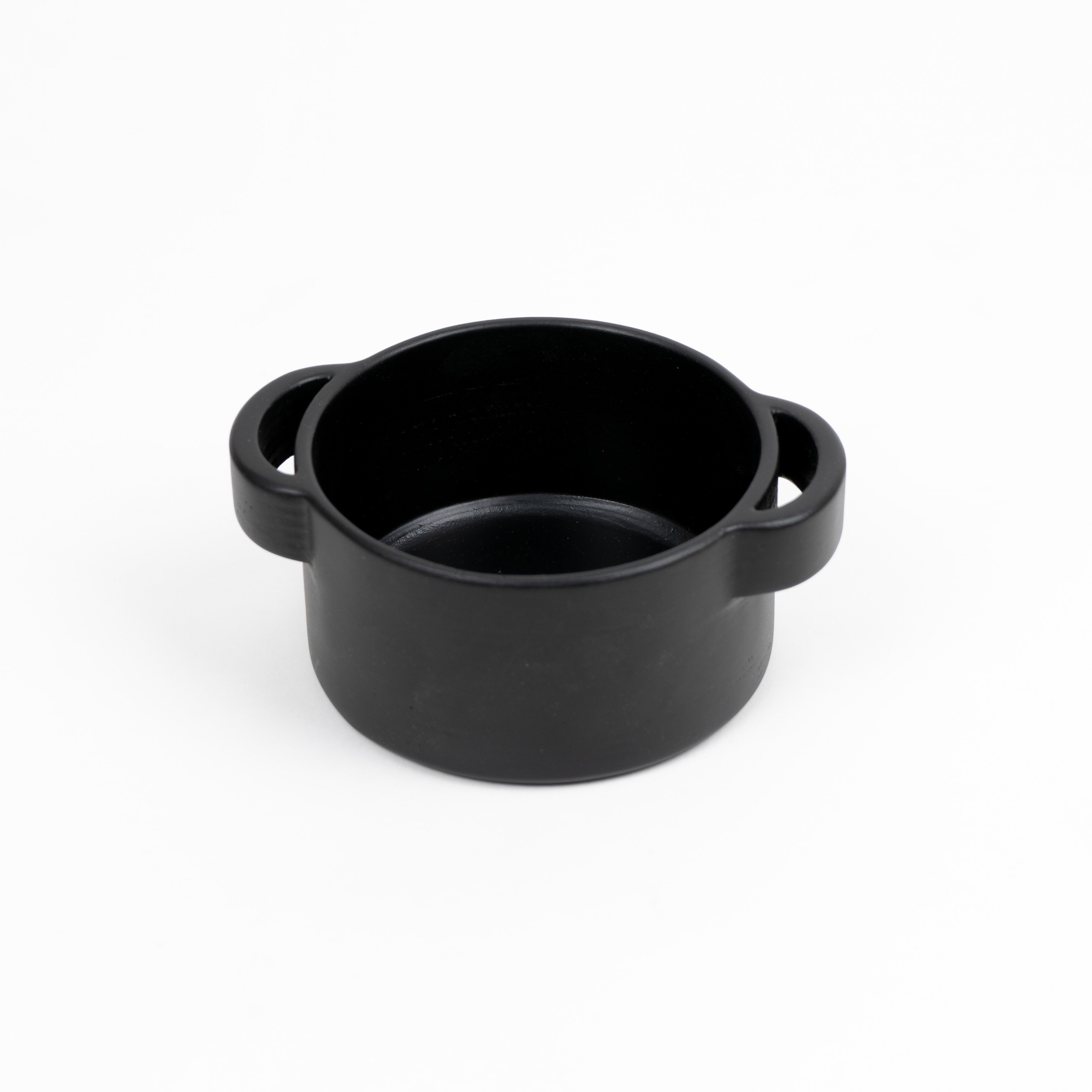 Black pot with handles on a white background