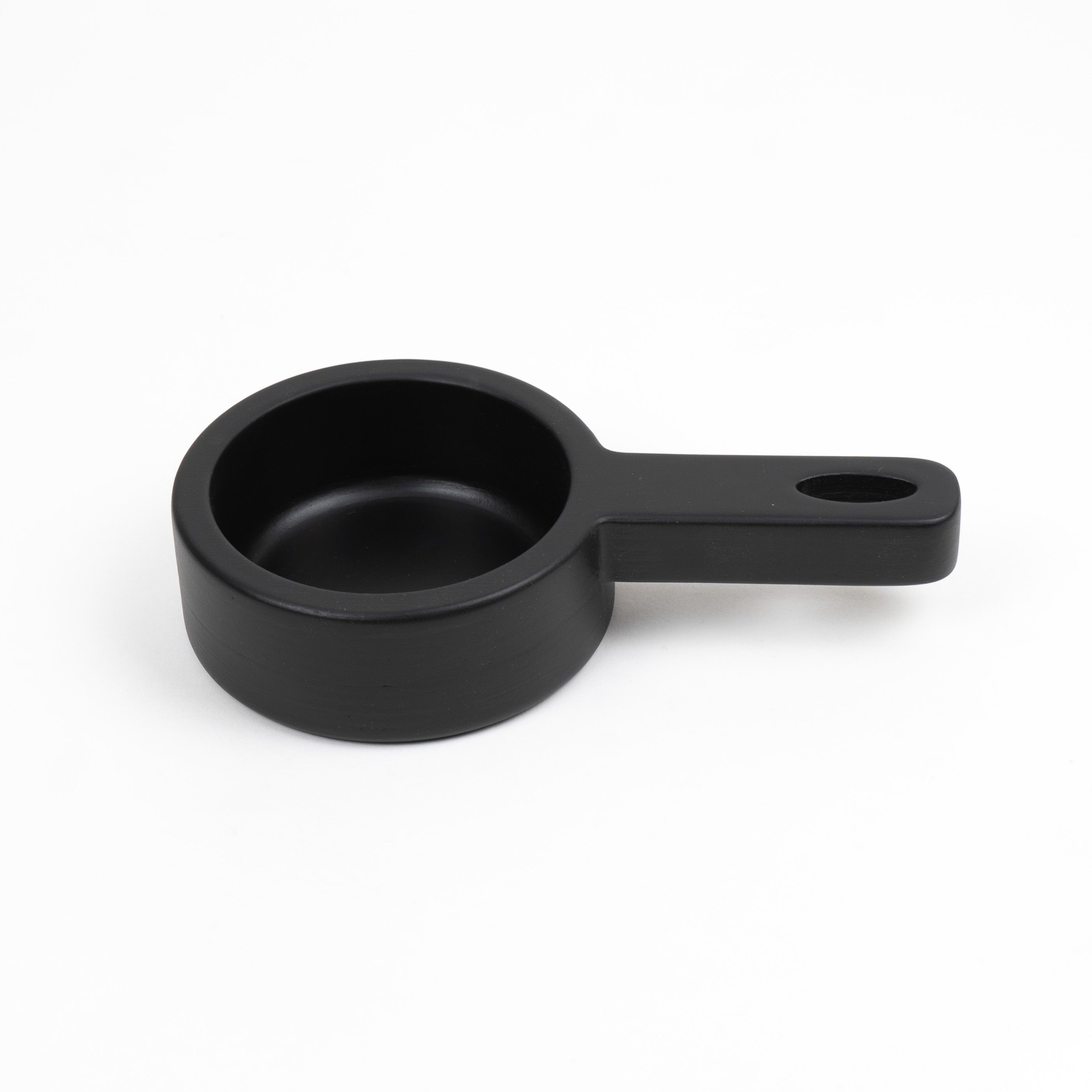 Black wooden toy pan on a white background