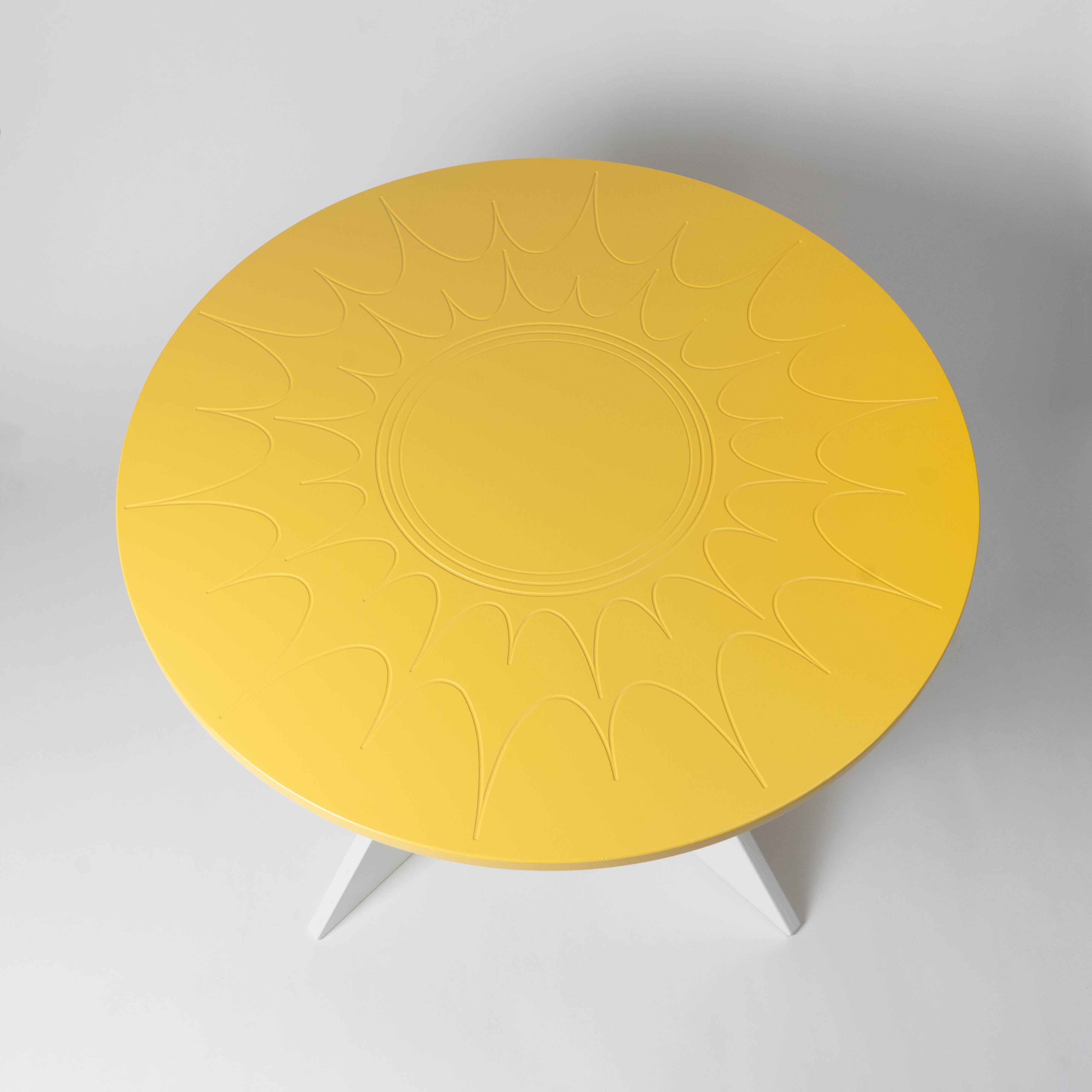 Yellow round table with a textured surface on a white background