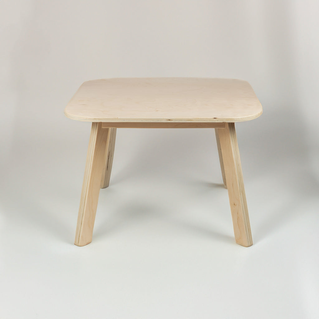 Wooden table with a light finish on a plain background