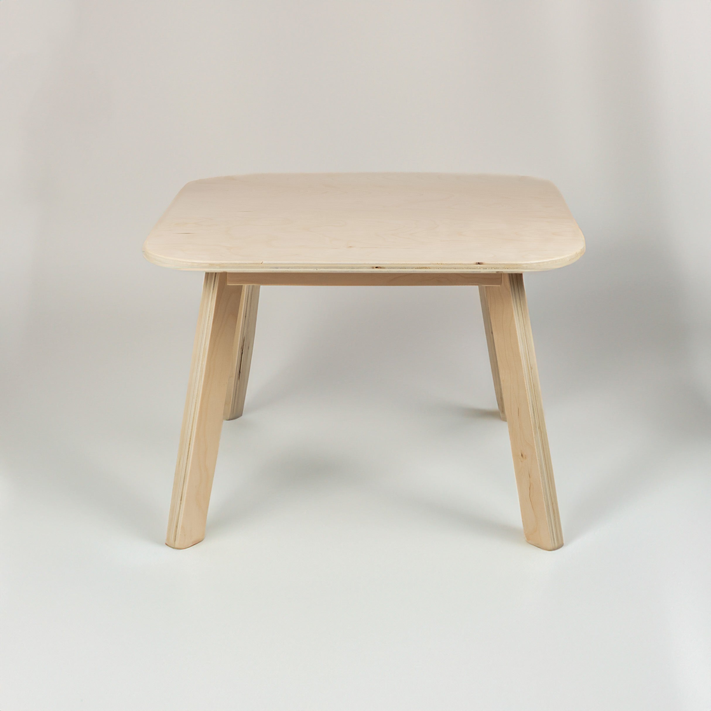 Wooden table with a light finish on a plain background