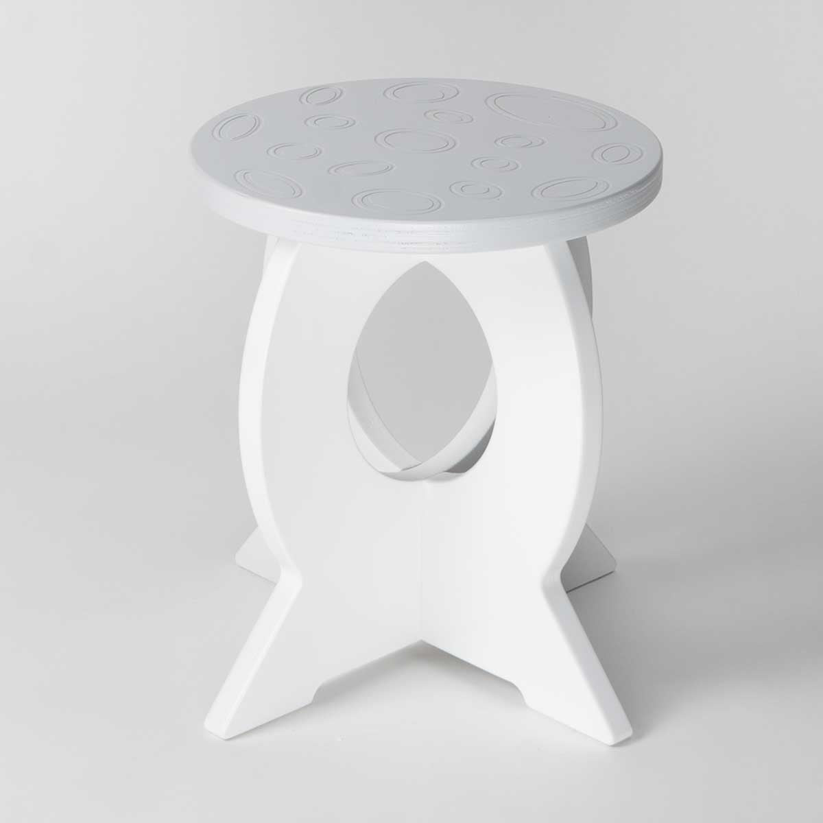 White stool with a moon design on a light gray background