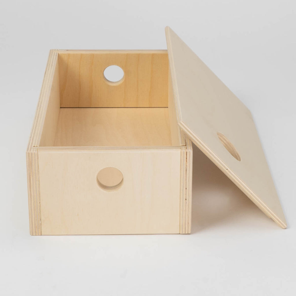 Wooden box with a lid on a light gray background