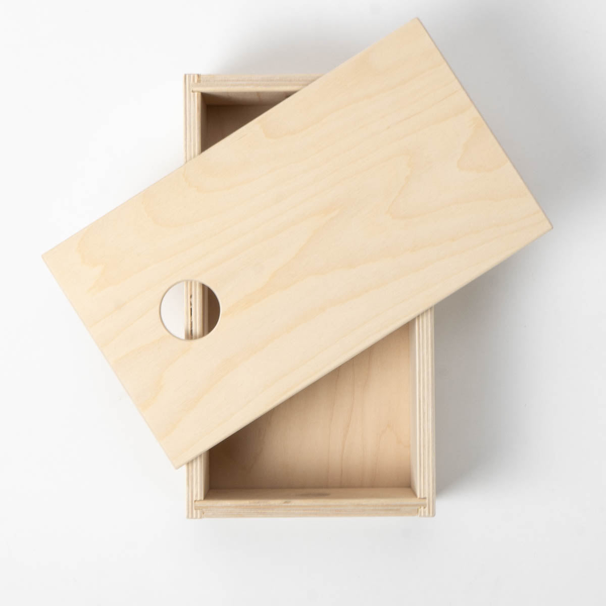 Wooden box with a lid on a white background