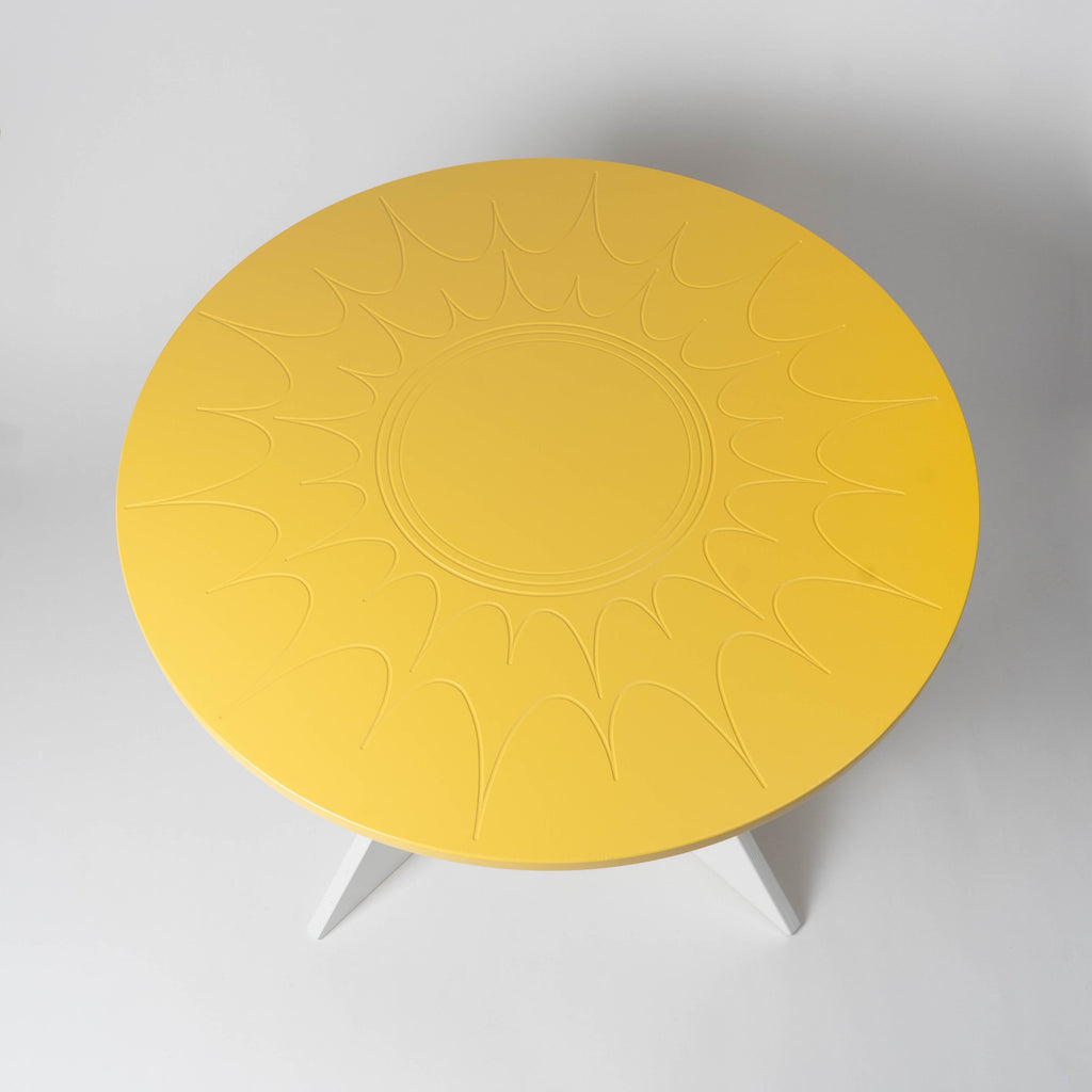 Yellow round table with a textured surface on a white background